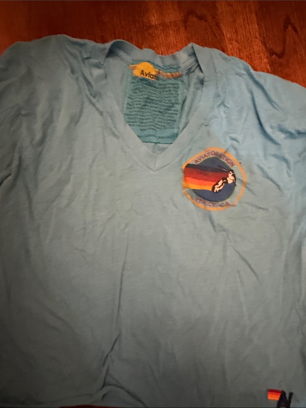 V-Neck women’s t Shirt with aviator nation logo. Raw hem. turquoise